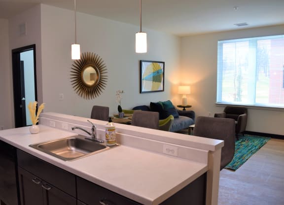 Image of a Kitchen Island and Living Room| Terraces at Arlington View | Affordable Arlington Apartments